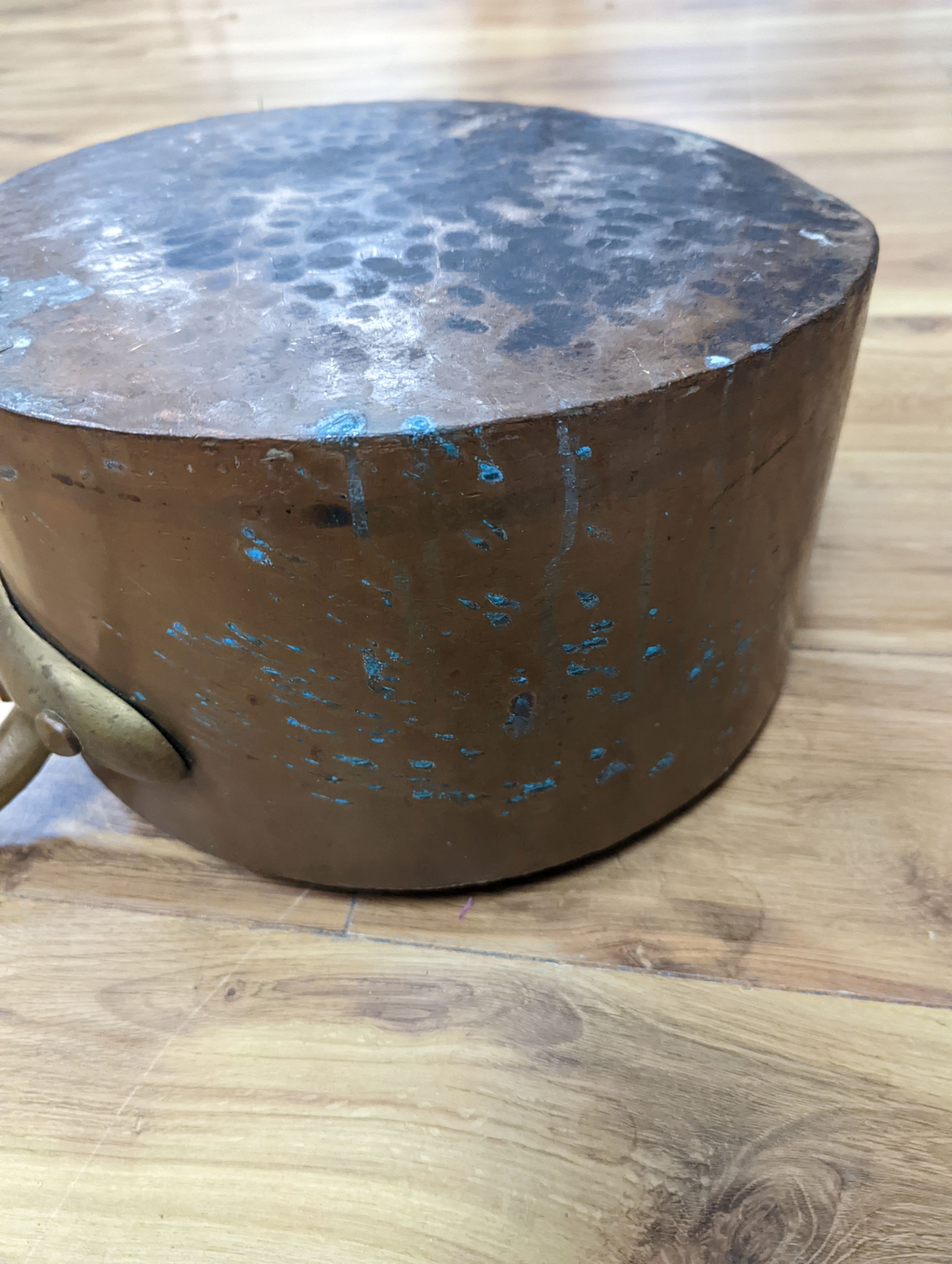 A group of three Jaeggi & Sons copper saucepans